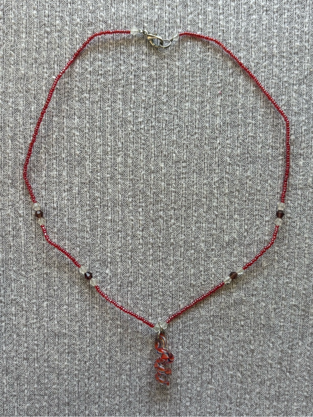 Pink, clear & dark beaded necklace w swirly red pendant